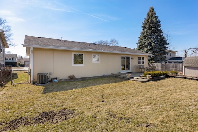 rear view of house featuring a gate, fence, central AC unit, a patio area, and a lawn