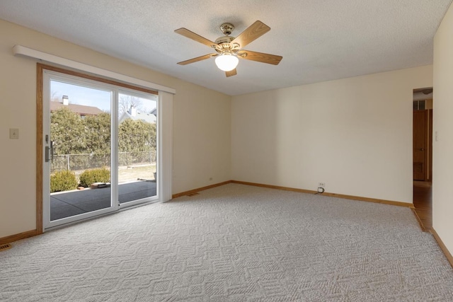 unfurnished room featuring light colored carpet, baseboards, and ceiling fan