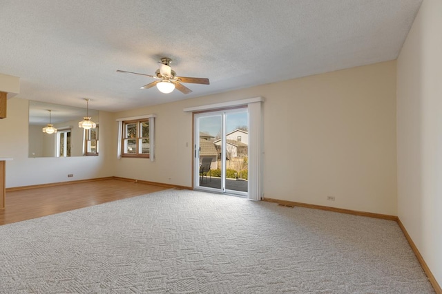 unfurnished room featuring carpet flooring, baseboards, and a ceiling fan