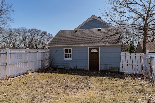 exterior space with a shingled roof and a fenced backyard