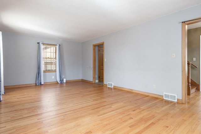 unfurnished room with visible vents, baseboards, and light wood-style flooring