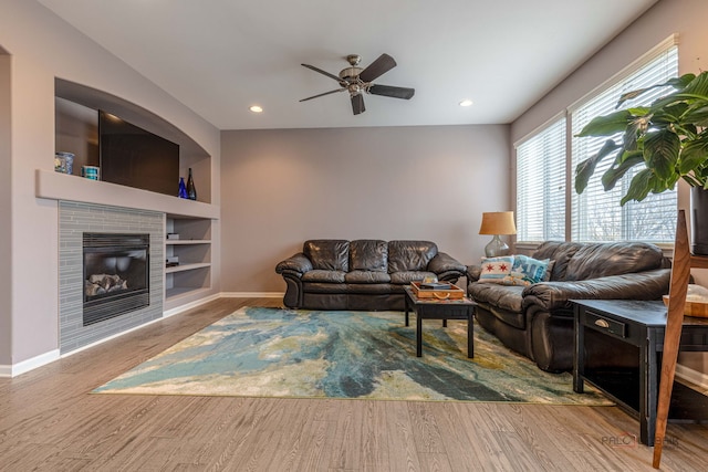 655 N Fox Trl, Round Lake, IL 60073 - living area featuring wood finished floors, a ceiling fan, baseboards, a tiled fireplace, and built in features