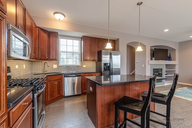 655 N Fox Trl, Round Lake, IL 60073 - kitchen featuring appliances with stainless steel finishes, a sink, wood finished floors, a kitchen breakfast bar, and recessed lighting