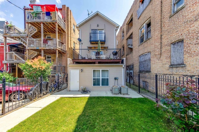 rear view of property with a yard, a patio area, central AC unit, and fence