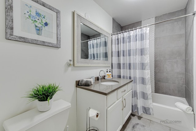 bathroom featuring shower / bath combo with shower curtain, toilet, vanity, and tile patterned flooring