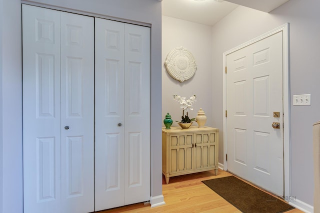 entrance foyer with light wood finished floors and baseboards