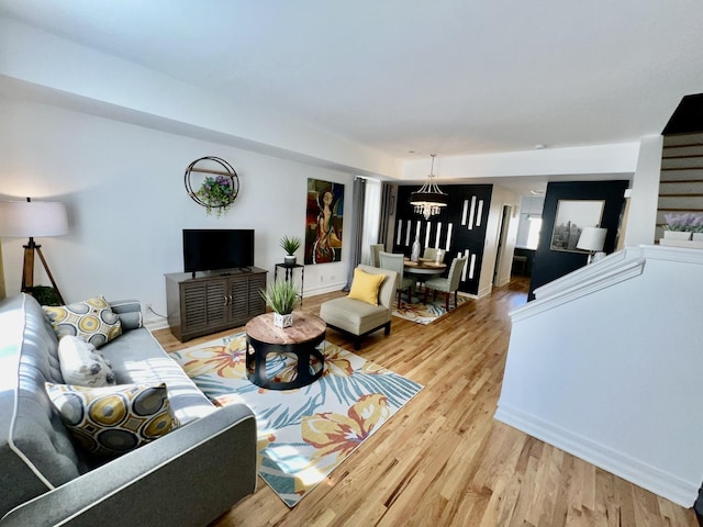 living area featuring a notable chandelier and light wood finished floors