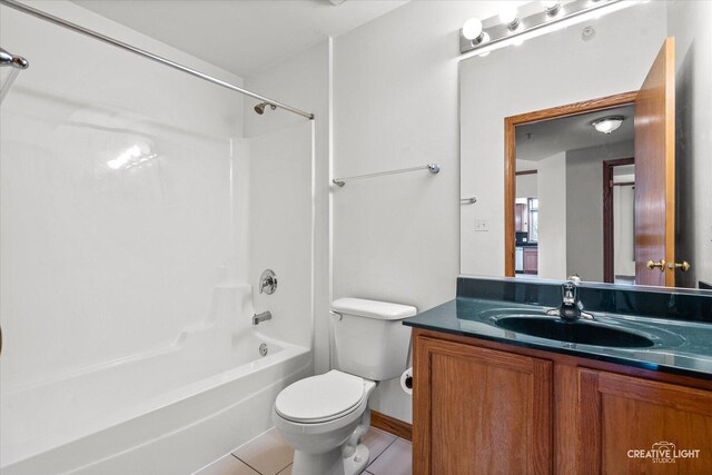 full bathroom with tile patterned floors, shower / bathtub combination, vanity, and toilet