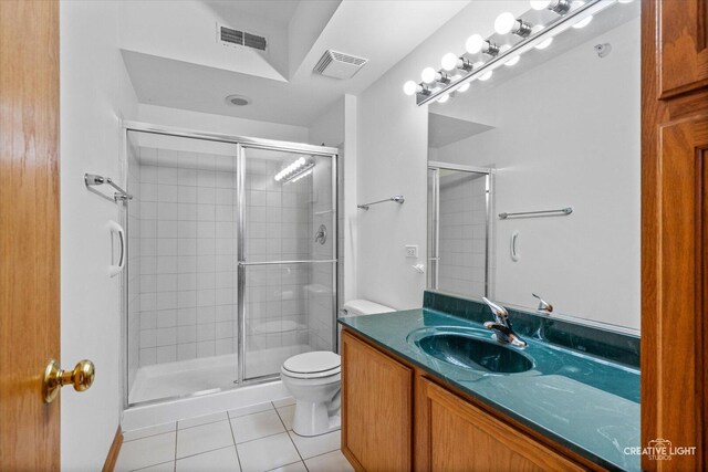 bathroom with visible vents, a stall shower, tile patterned floors, and toilet