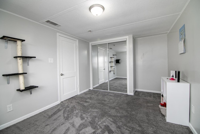 unfurnished bedroom featuring visible vents, baseboards, a closet, and carpet flooring