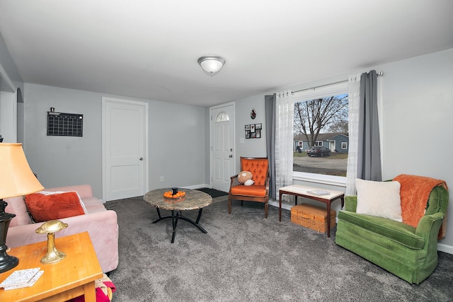 living room featuring carpet and baseboards