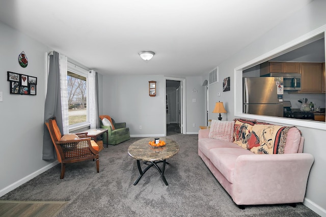 living room featuring visible vents, carpet flooring, and baseboards