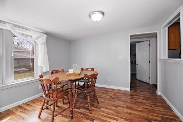 dining space featuring a healthy amount of sunlight, baseboards, and wood finished floors