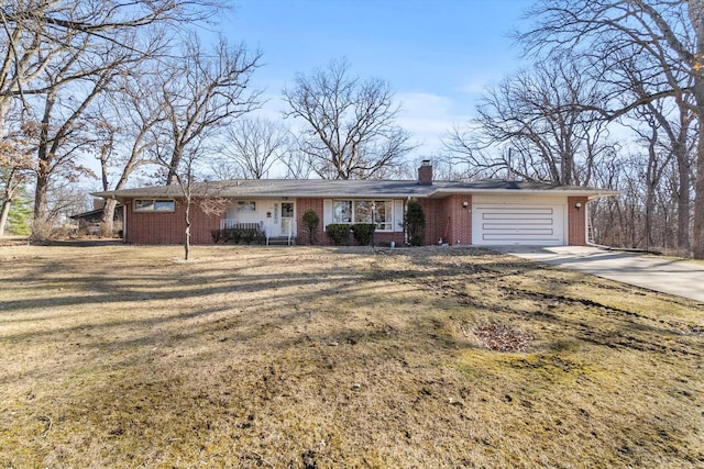 ranch-style home with a front yard, an attached garage, a chimney, concrete driveway, and brick siding