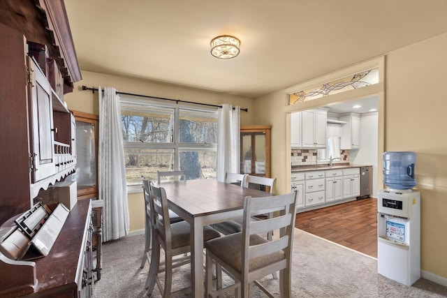 dining space featuring carpet flooring and baseboards