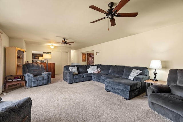 living room featuring carpet and ceiling fan