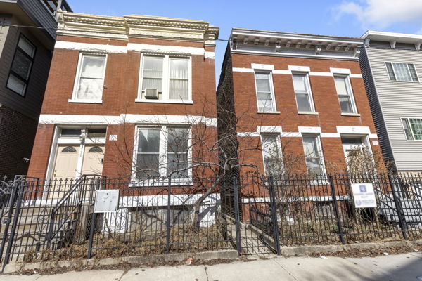 2016 W Superior St, Chicago, IL 60612 - townhome / multi-family property with brick siding and a fenced front yard