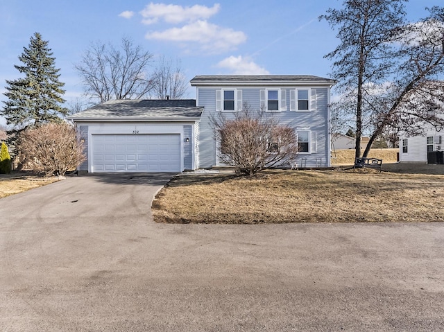 traditional-style home with aphalt driveway and a garage