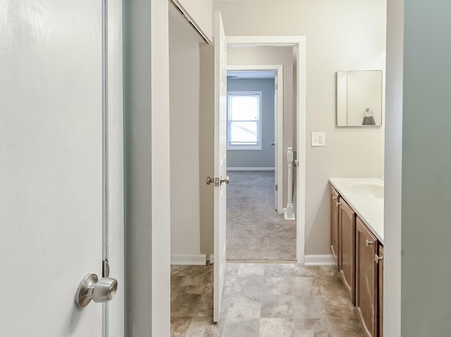 bathroom with vanity and baseboards