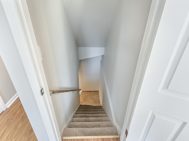 stairs featuring baseboards and wood finished floors