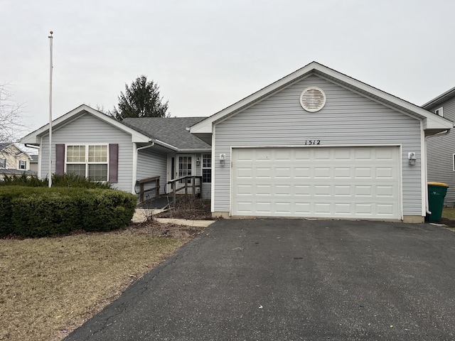 ranch-style home with an attached garage and driveway