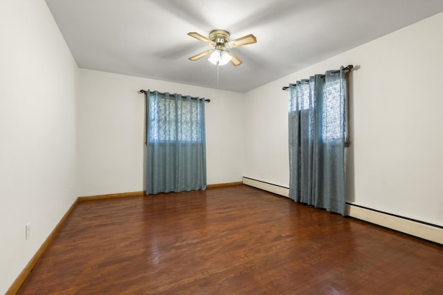 empty room with baseboards, wood finished floors, and ceiling fan