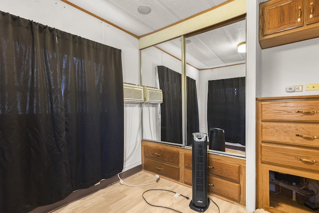 bedroom with a textured ceiling and light wood-type flooring