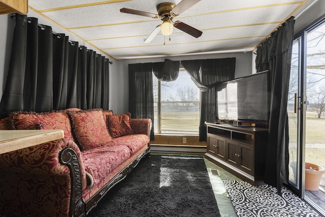 living room featuring a textured ceiling and ceiling fan
