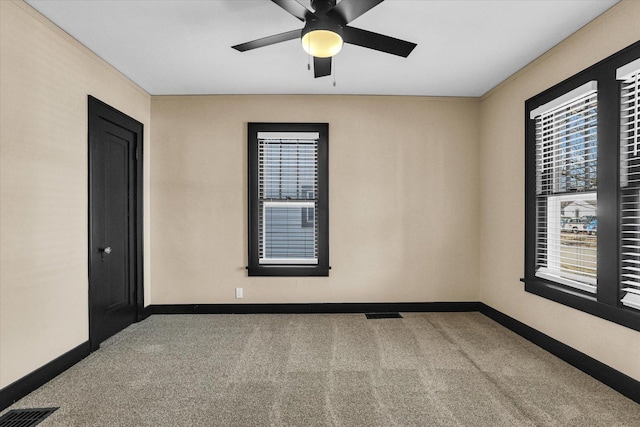 unfurnished room featuring visible vents, baseboards, ceiling fan, and carpet flooring