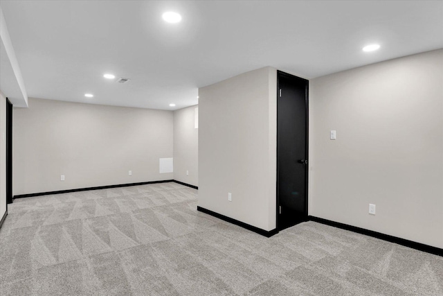 finished below grade area with recessed lighting, visible vents, baseboards, and light colored carpet