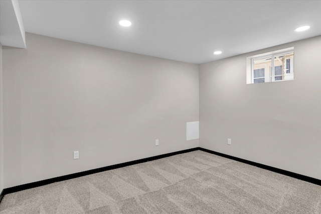 below grade area featuring recessed lighting, baseboards, and carpet