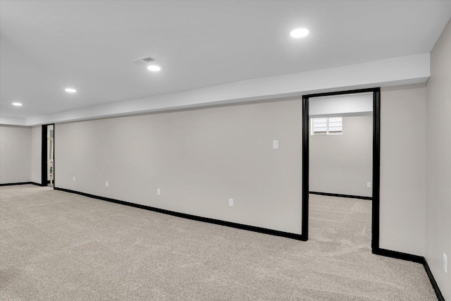 basement with recessed lighting, baseboards, and light carpet