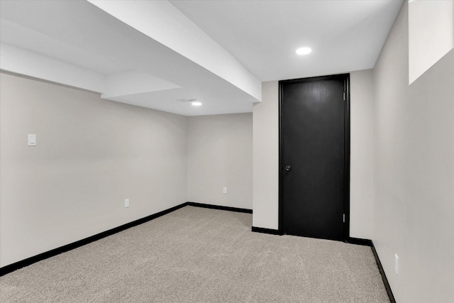 empty room featuring recessed lighting, baseboards, and light carpet