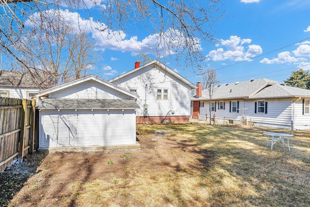 back of house featuring a yard and fence