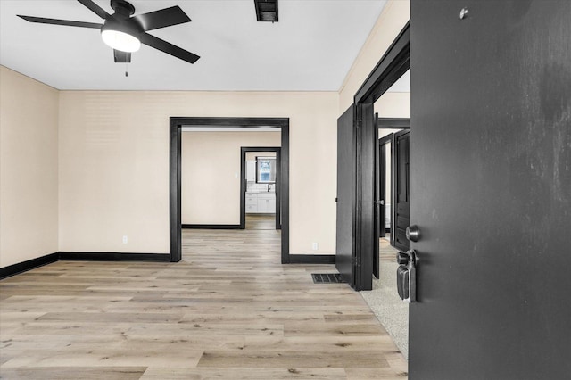 interior space featuring visible vents, ceiling fan, and light wood finished floors