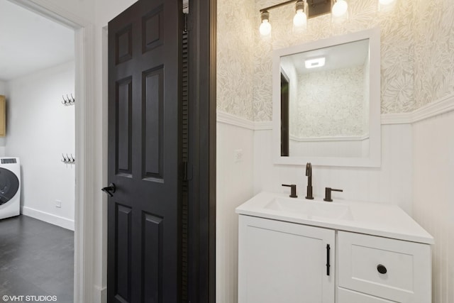 bathroom featuring wallpapered walls, vanity, and a wainscoted wall