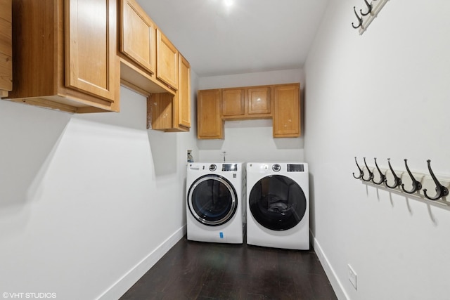 washroom with cabinet space, dark wood-type flooring, independent washer and dryer, and baseboards