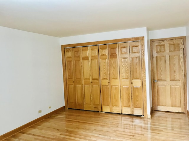 195 N Harbor Dr Unit 207, Chicago, IL 60601 - unfurnished bedroom with a closet, light wood-style flooring, and baseboards