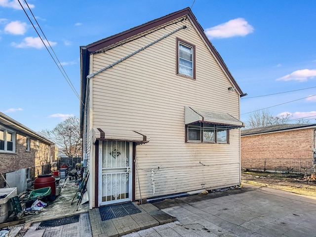rear view of property with a patio and fence
