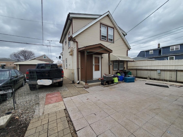 view of front facade featuring a patio and fence