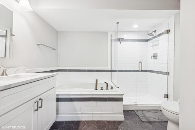 full bathroom featuring a bath, tile patterned floors, a stall shower, toilet, and vanity