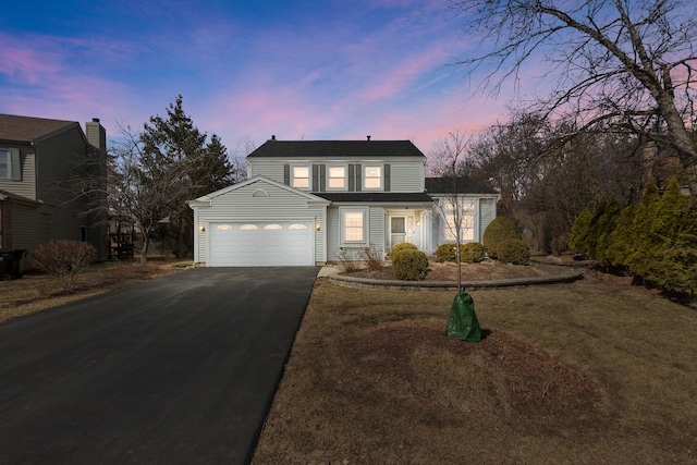 traditional-style house with an attached garage and driveway