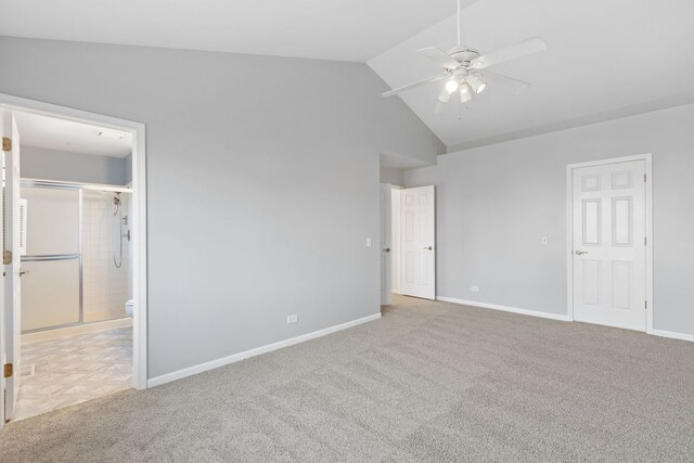 unfurnished bedroom with lofted ceiling, a ceiling fan, ensuite bath, carpet, and baseboards