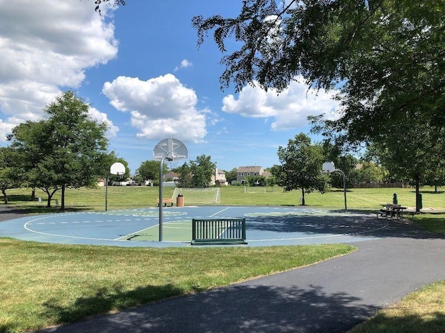 view of basketball court with a lawn and community basketball court