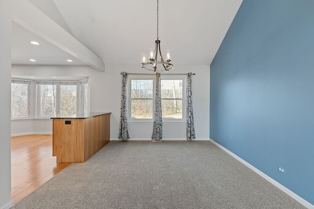 unfurnished dining area with baseboards, vaulted ceiling with beams, recessed lighting, light carpet, and a notable chandelier