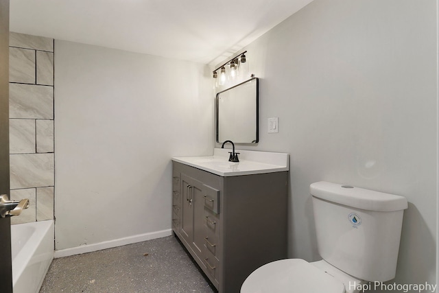 full bathroom with toilet, a bathtub, baseboards, and vanity