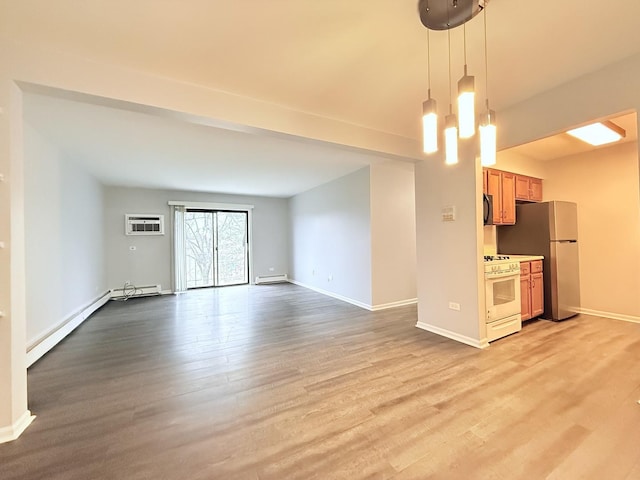 unfurnished living room featuring baseboards, baseboard heating, light wood-style floors, a wall mounted AC, and a baseboard radiator