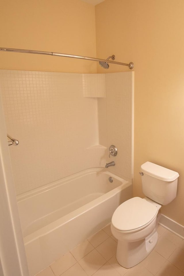 full bathroom with tile patterned floors, toilet, shower / bathing tub combination, and baseboards