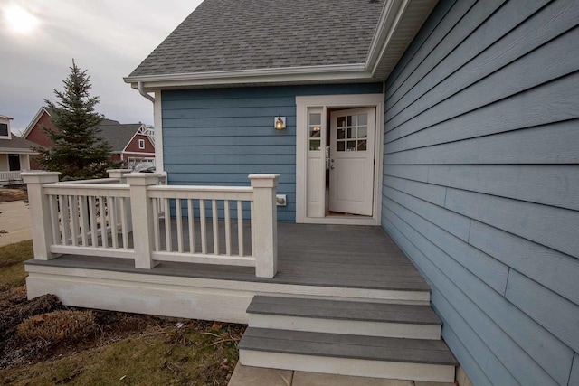 property entrance featuring roof with shingles