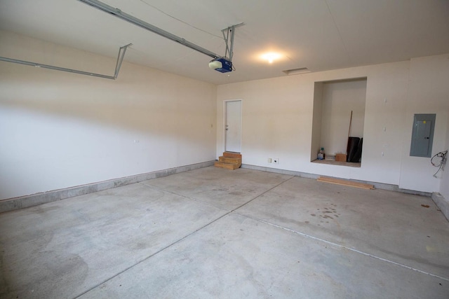 garage with electric panel, baseboards, and a garage door opener